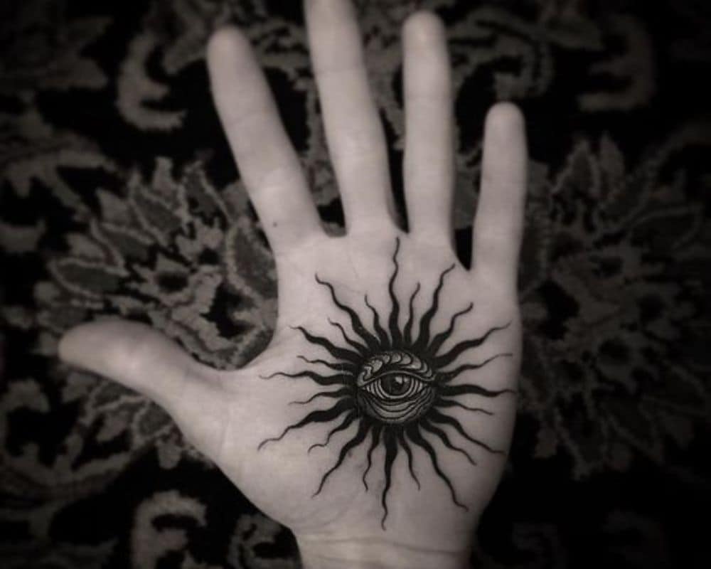 black sun tattoo arm