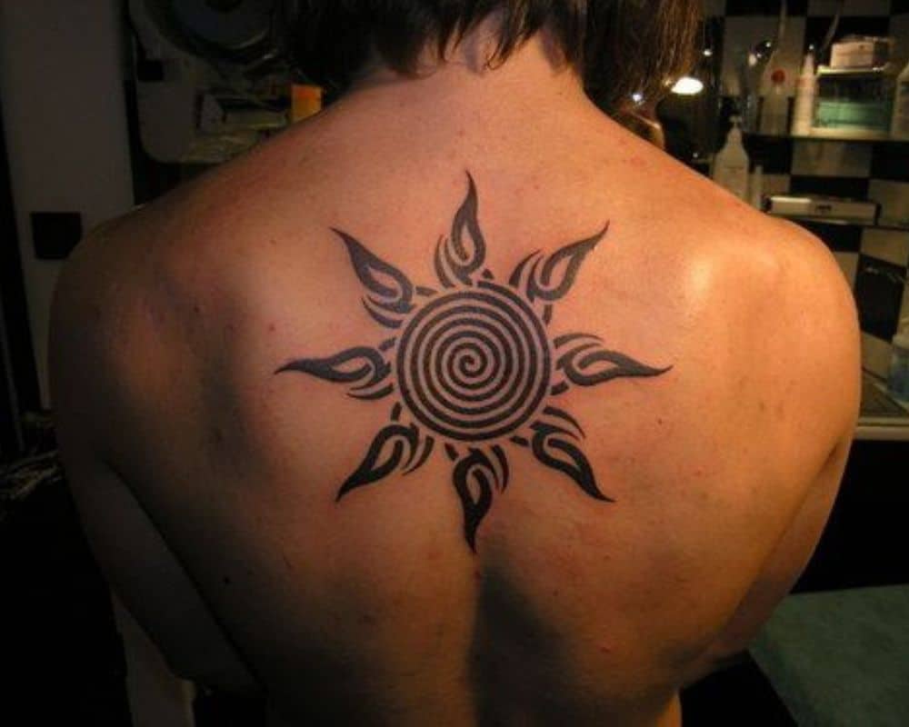 black sun tattoo on the skin
