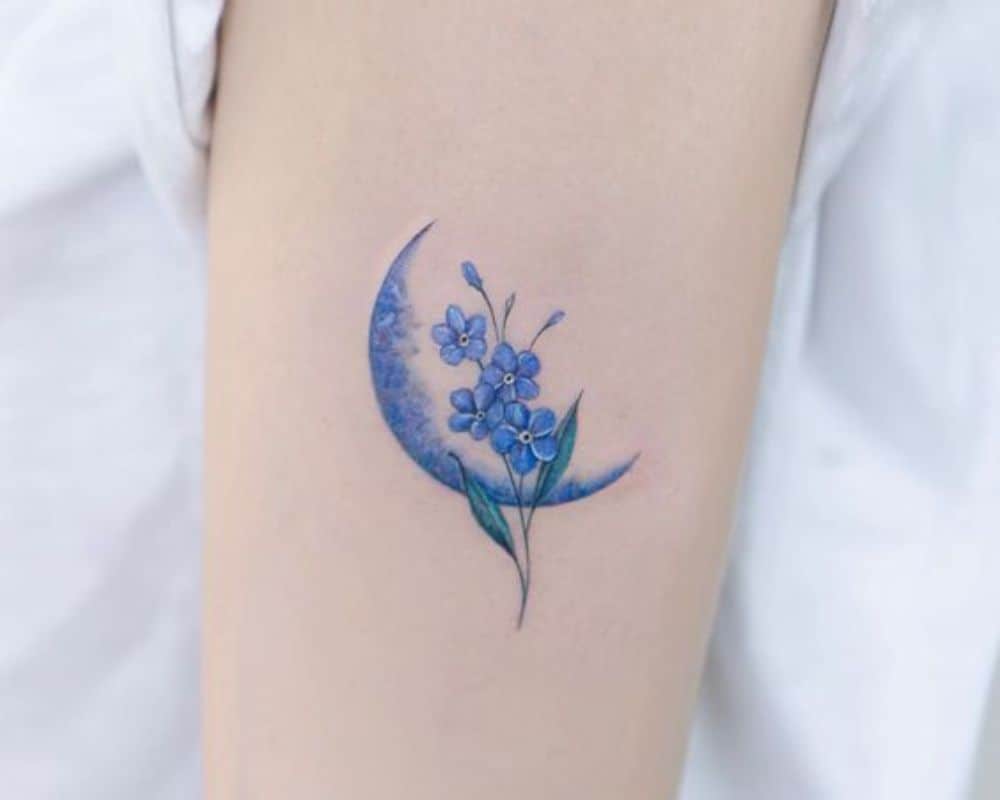 tattoo with the moon and flowers