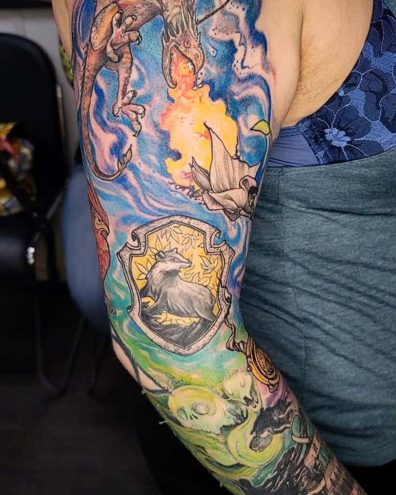 A colourful tattoo of Ukrainian Ironbelly, Harry on a broomstick and the Hufflepuff symbol