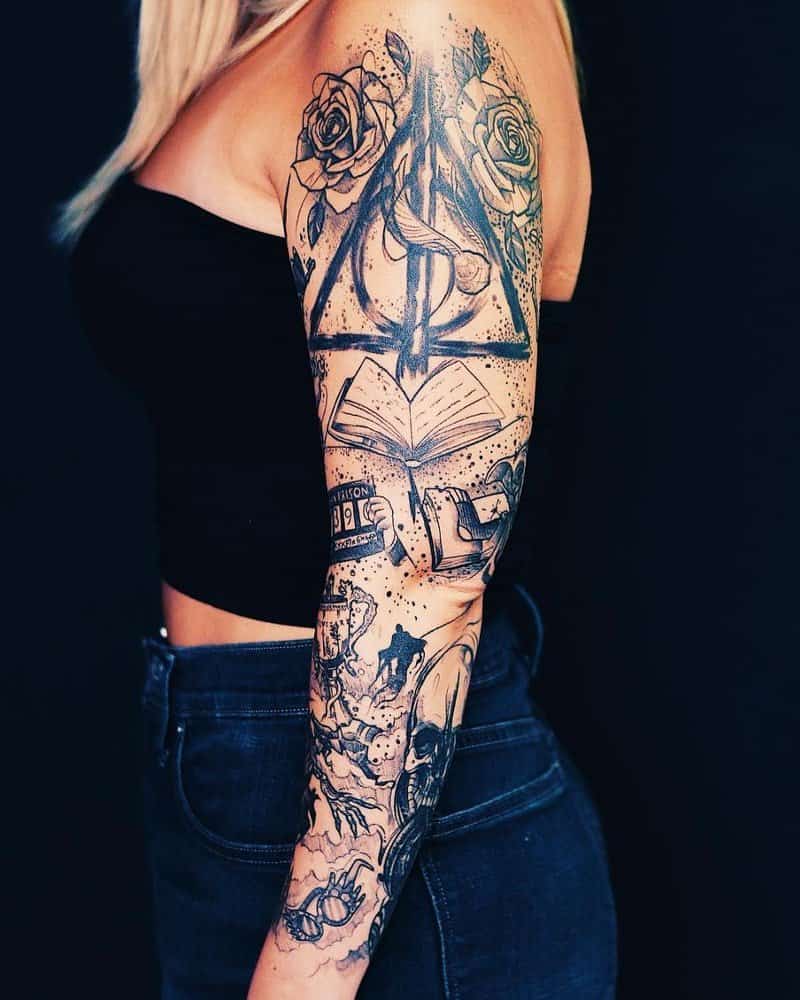 A full arm tattoo with the symbol of the Deathly Hallows, books and the symbol of the Death Eaters