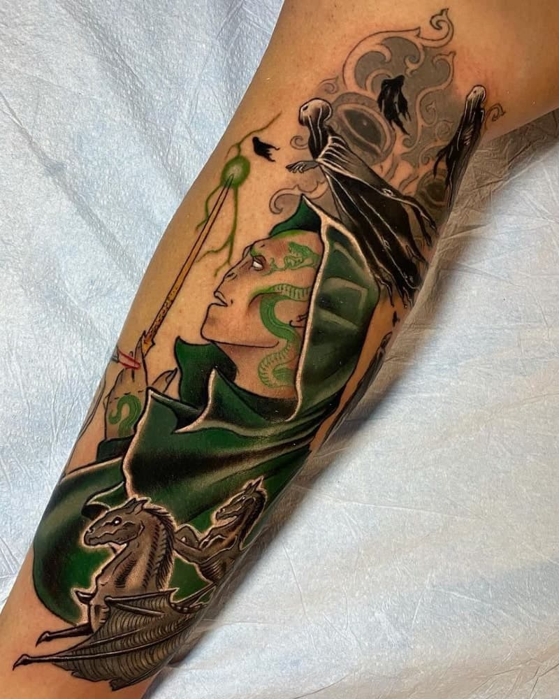 A green tattoo of Voldemort, Dementors and Thestrals
