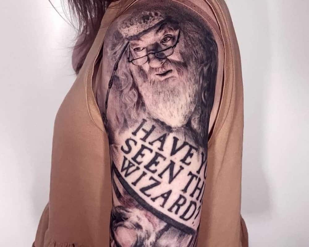 A realistic tattoo with Dumbledore and the inscription Have you seen the wizard