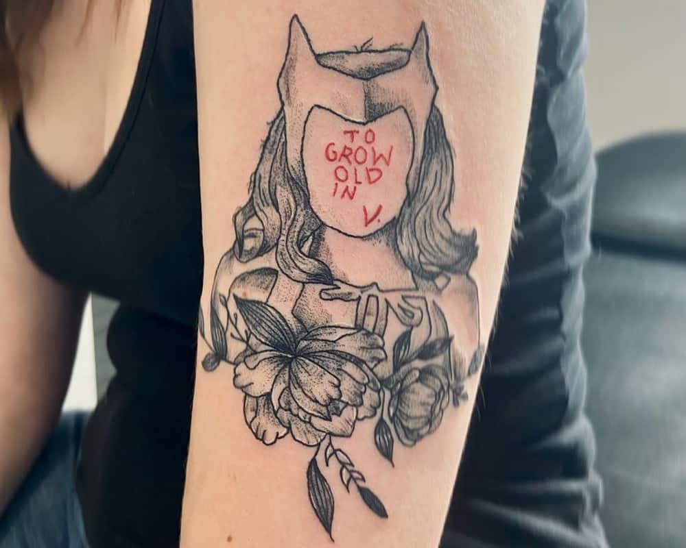 A tattoo in the shape of Wanda who has the inscription "to grow old in V." instead of her face