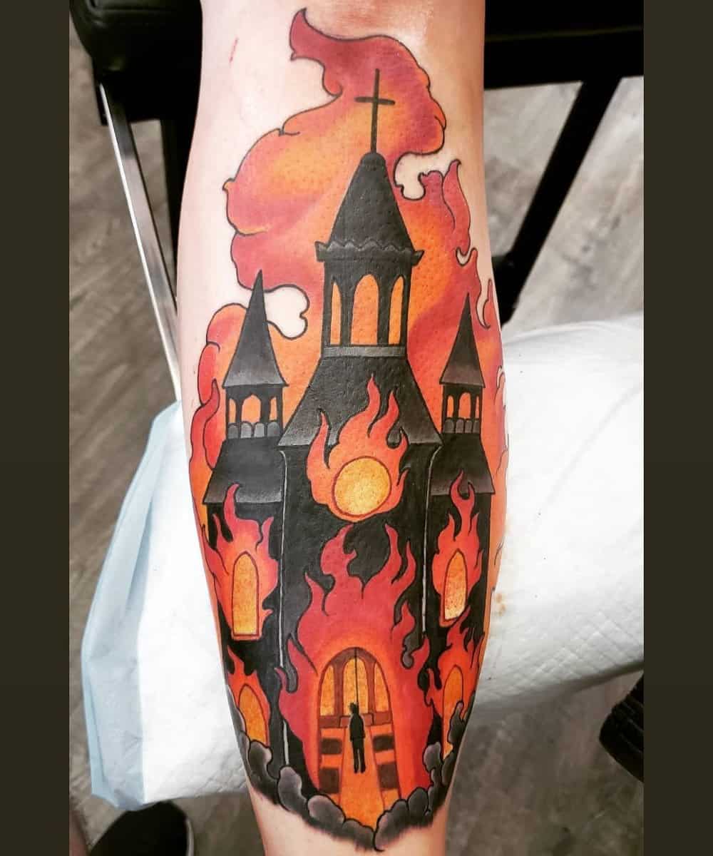 A tattoo of a burning church with a hanged man inside