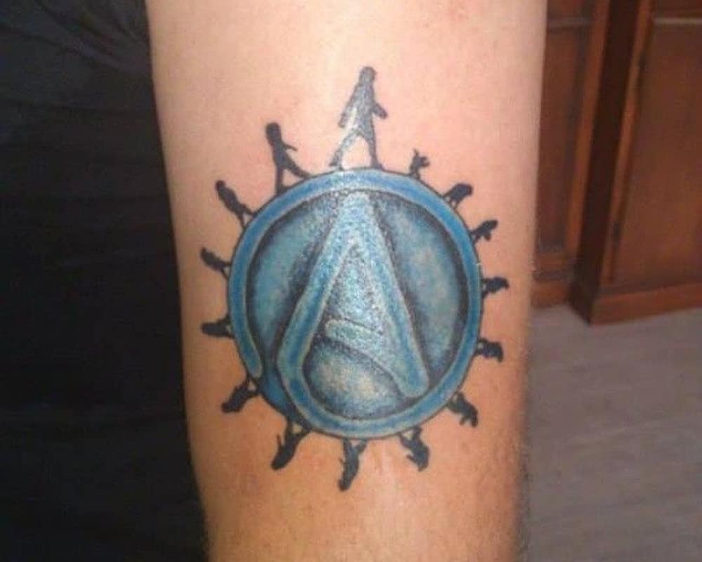 A tattoo of the symbol A and an image of Darwin's theory around it