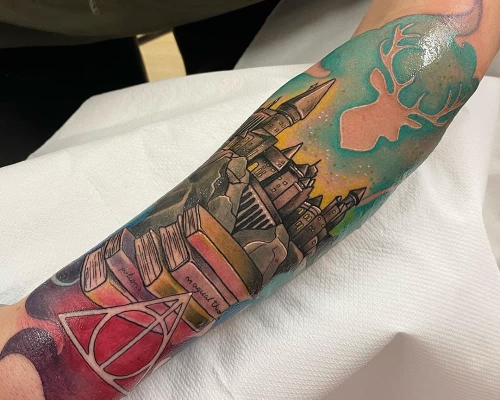 Colour tattoo with Hogwarts, books, Deathly Hallows and stag