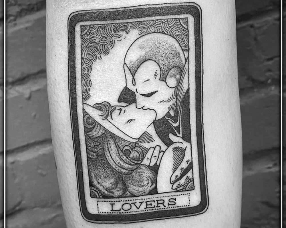 Tattoo of card with Wanda and Vision kissing and the word "lovers"