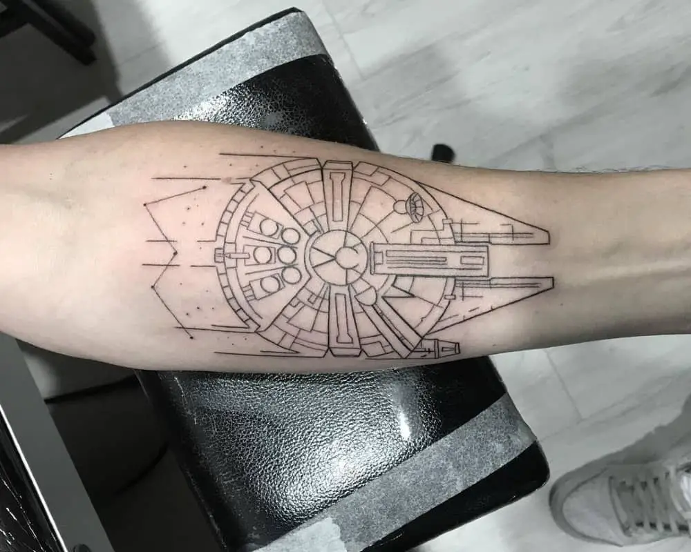Tattoo of the Millennium Falcon ship on the arm