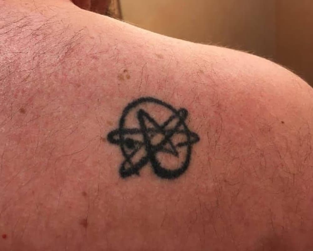 Tattoo of the atom symbol