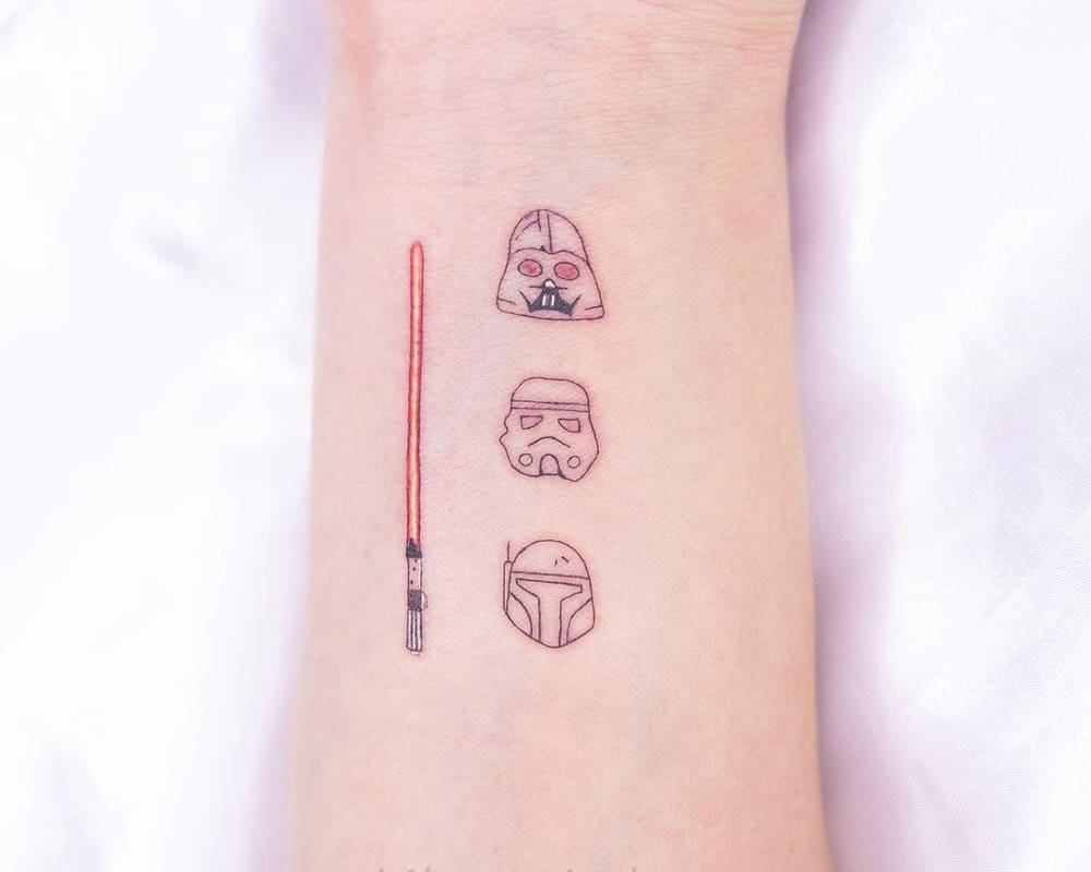 Tattoos depicting a lightsaber and Darth Vader Imperial and Mandalorian helmet