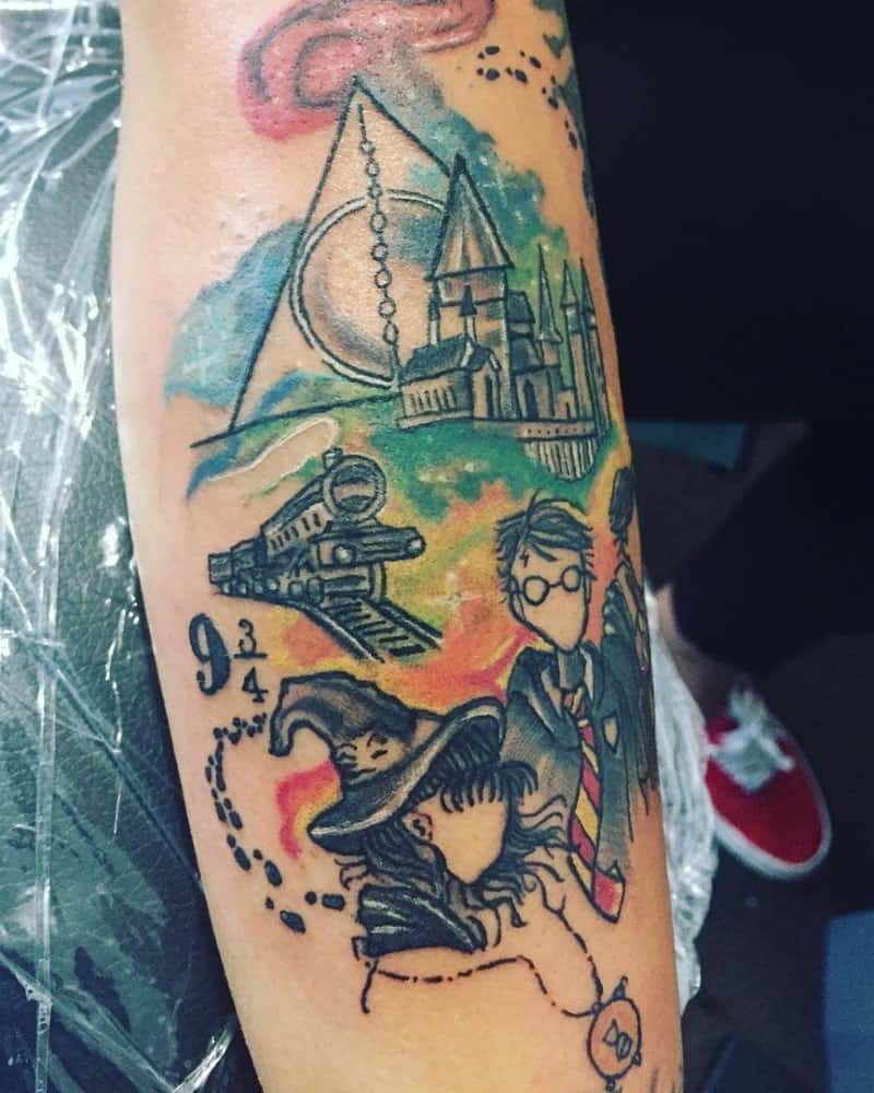 coloured tattoo with the three heroes, train, Hogwarts and the Deathly Hallows sign
