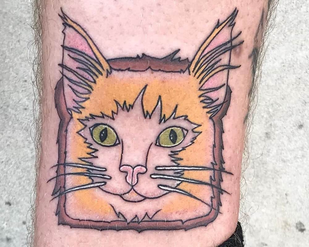 tattoo in the shape of toast with a cat's face