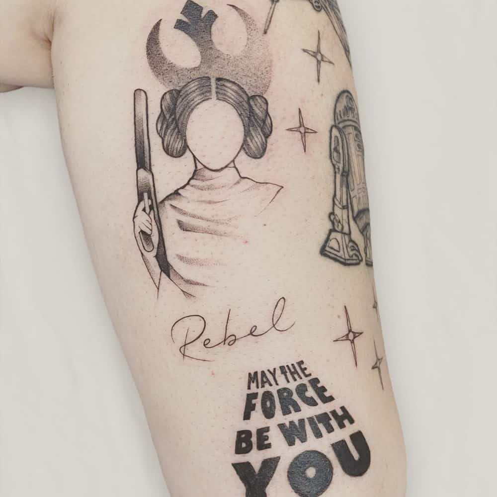 tattoo of Princess Leia with a gun and the inscription May the force be with you