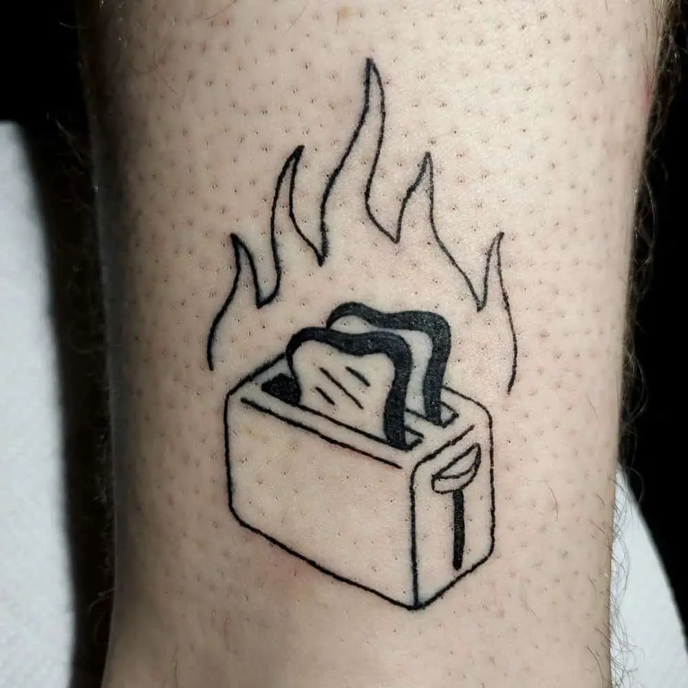 tattoo of a burning toaster with toast