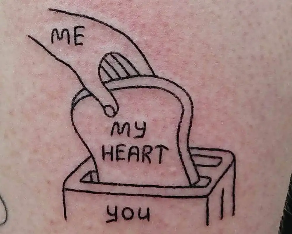 tattoo of a hand putting bread in a toaster and the words "me, my heart, you"