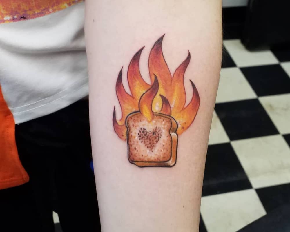 tattoo of burning toast with a heart in the centre