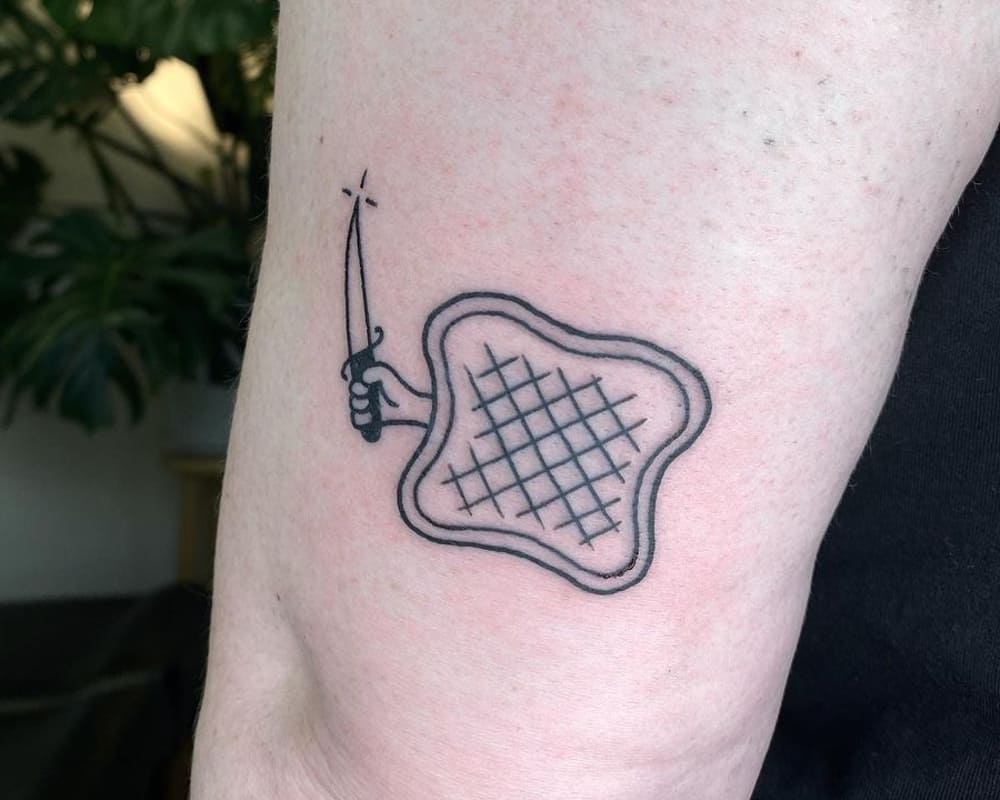 tattoo of toast with a knife