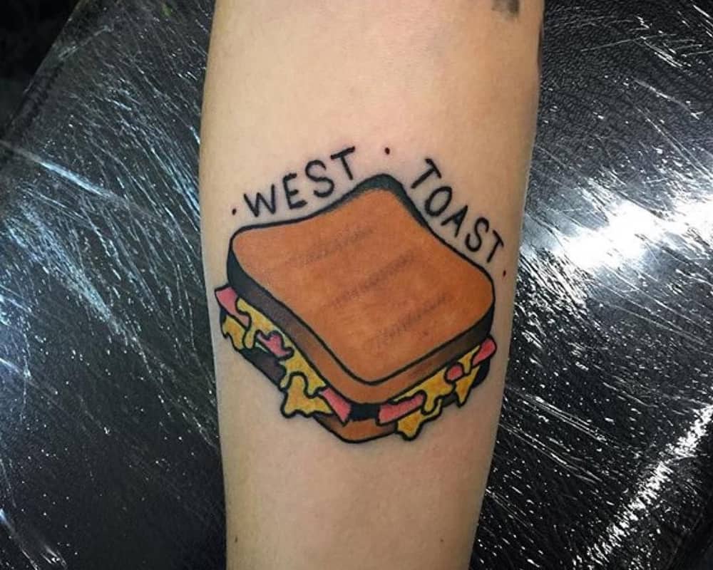 tattoo of toast with cheese and writing west toast