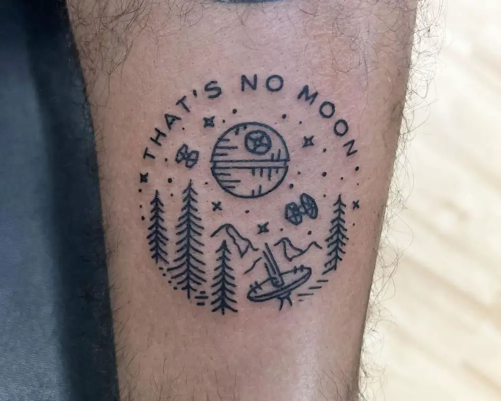 tattoo of landscape with a death star and the inscription that's no moon