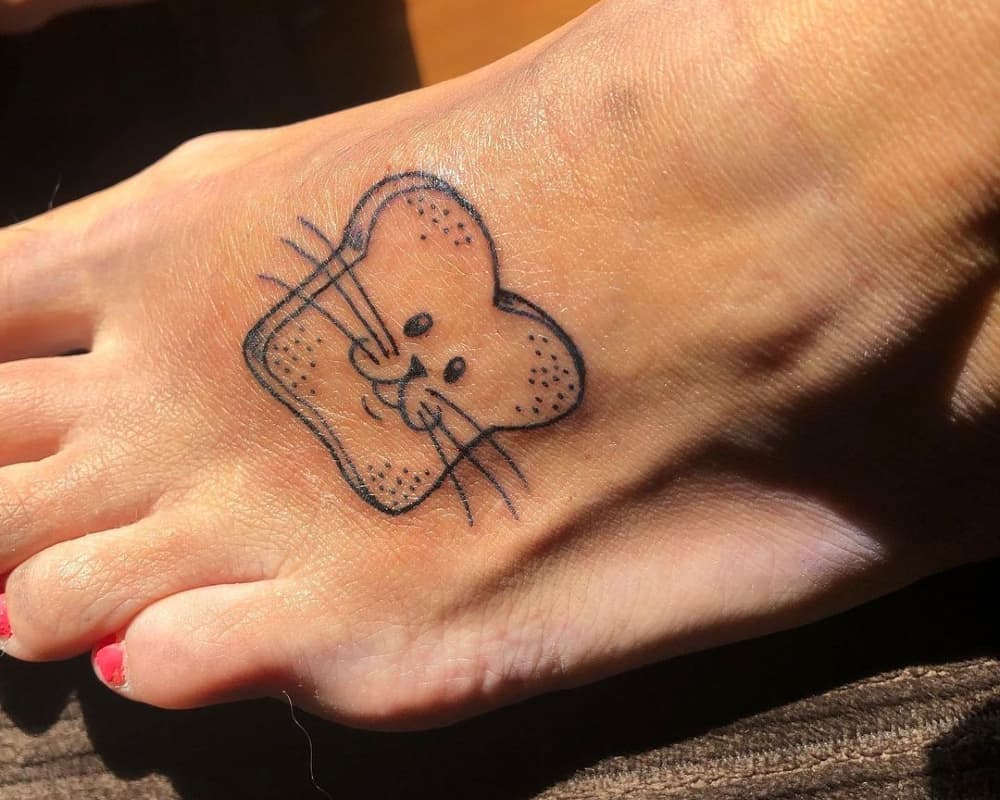 toast tattoo with animal's muzzle on the foot