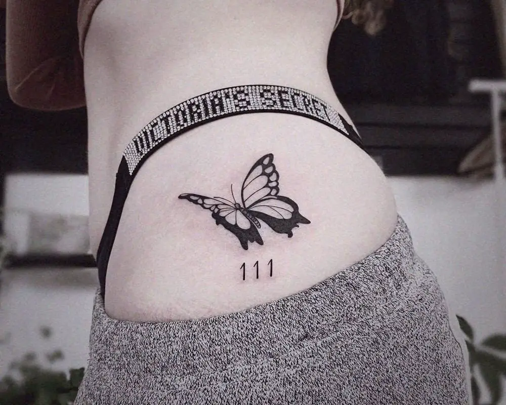 111 tattoo and butterfly on the thigh