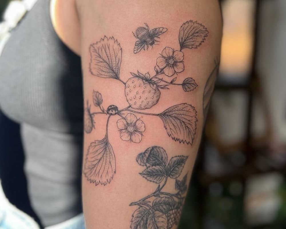 A delicate tattoo of a flowering strawberry bush