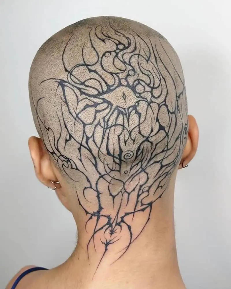 A full head tattoo in the shape of a pattern and an eye