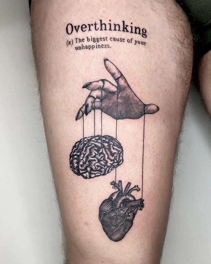 A tattoo in the form of a hand that manipulates the brain and the heart with strings