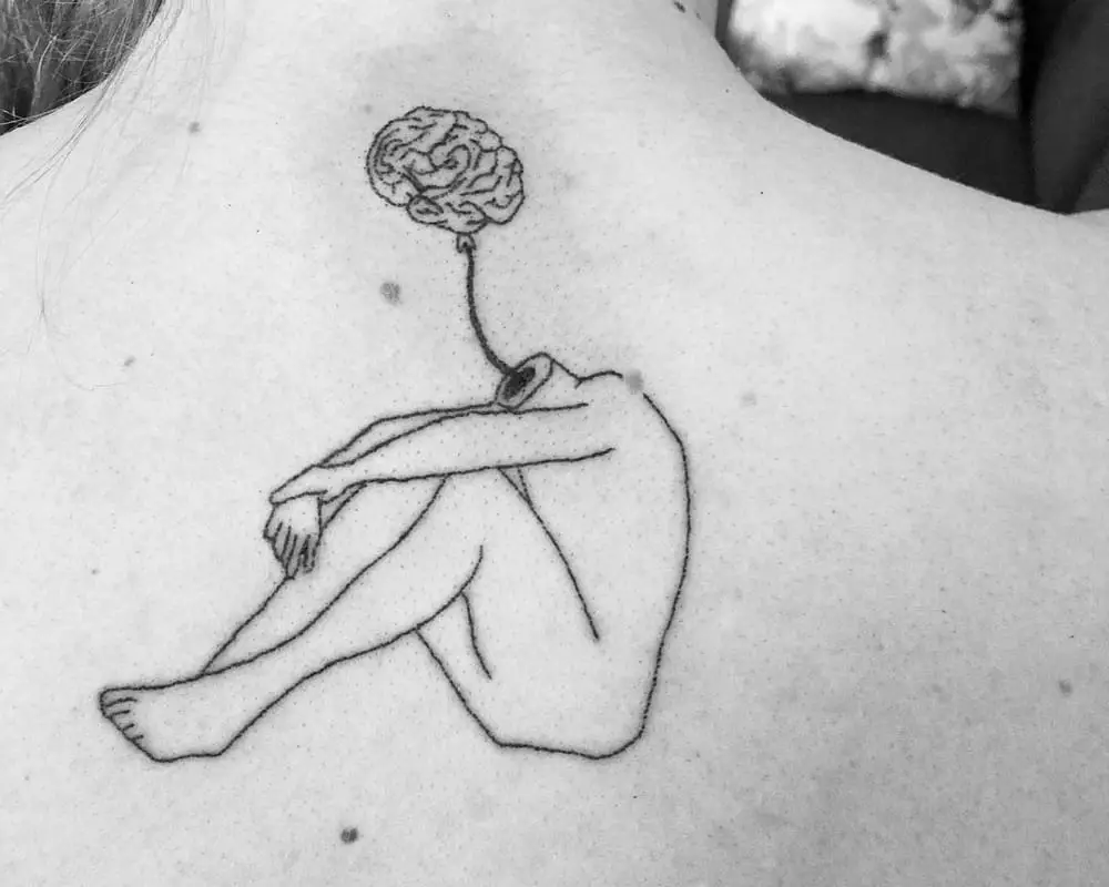 A tattoo in the form of a seated silhouette of a headless man with a brain on a rope