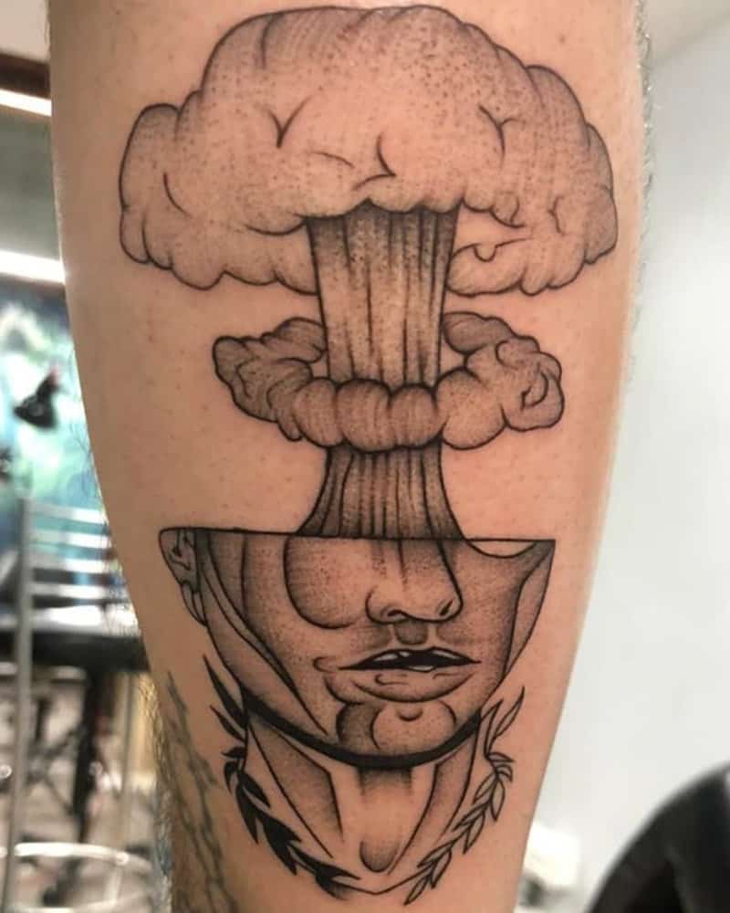 A tattoo in the form of half a head and an explosion