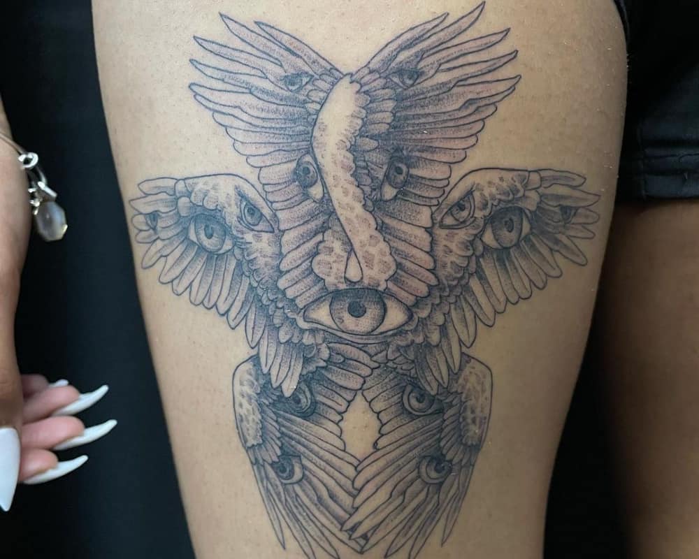 A tattoo in the form of six wings with two pairs of eyes on them