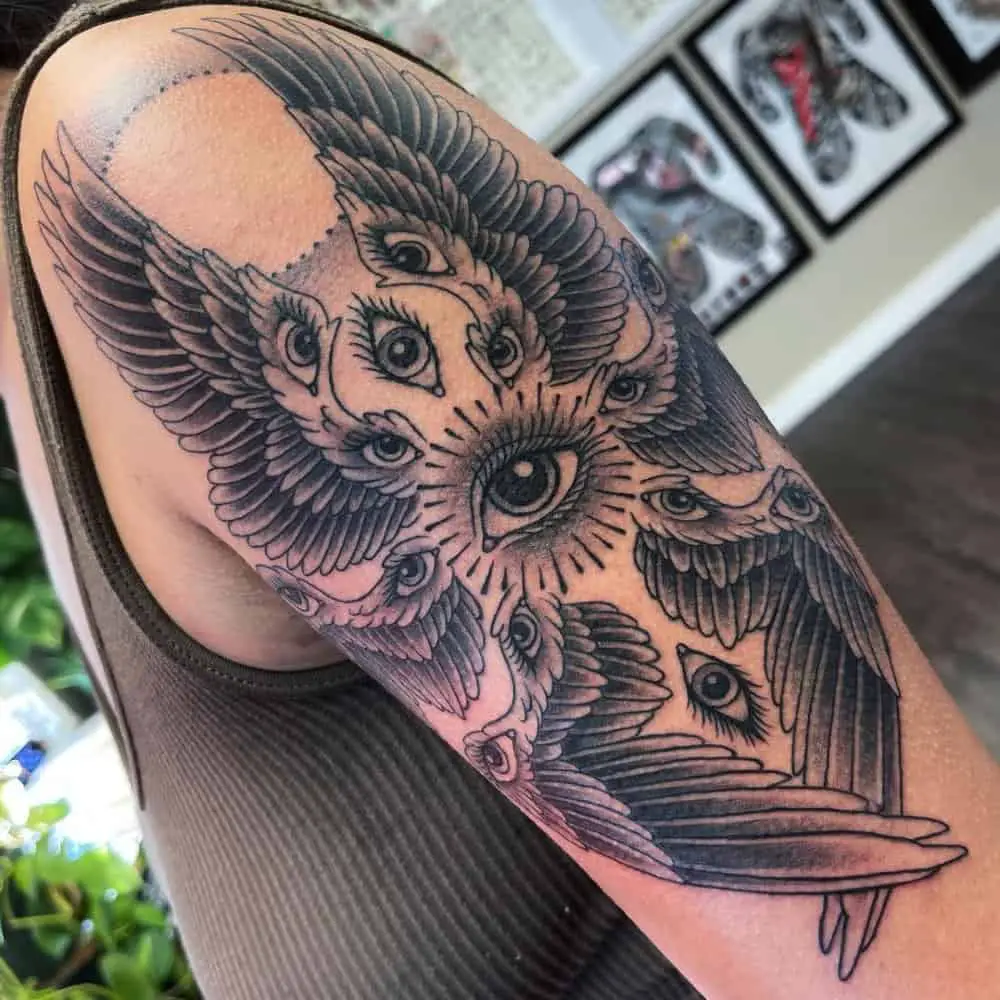 A tattoo in the form of wings with eyes