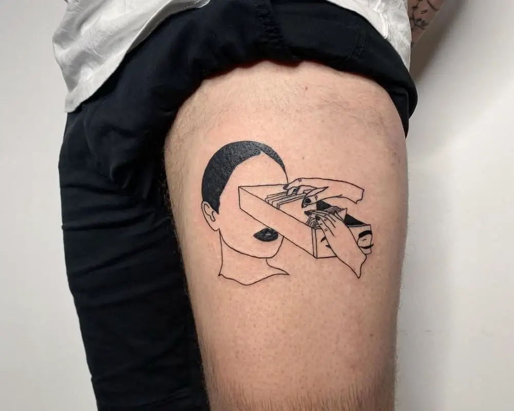 A tattoo in the shape of a head from which a file cabinet is pulled