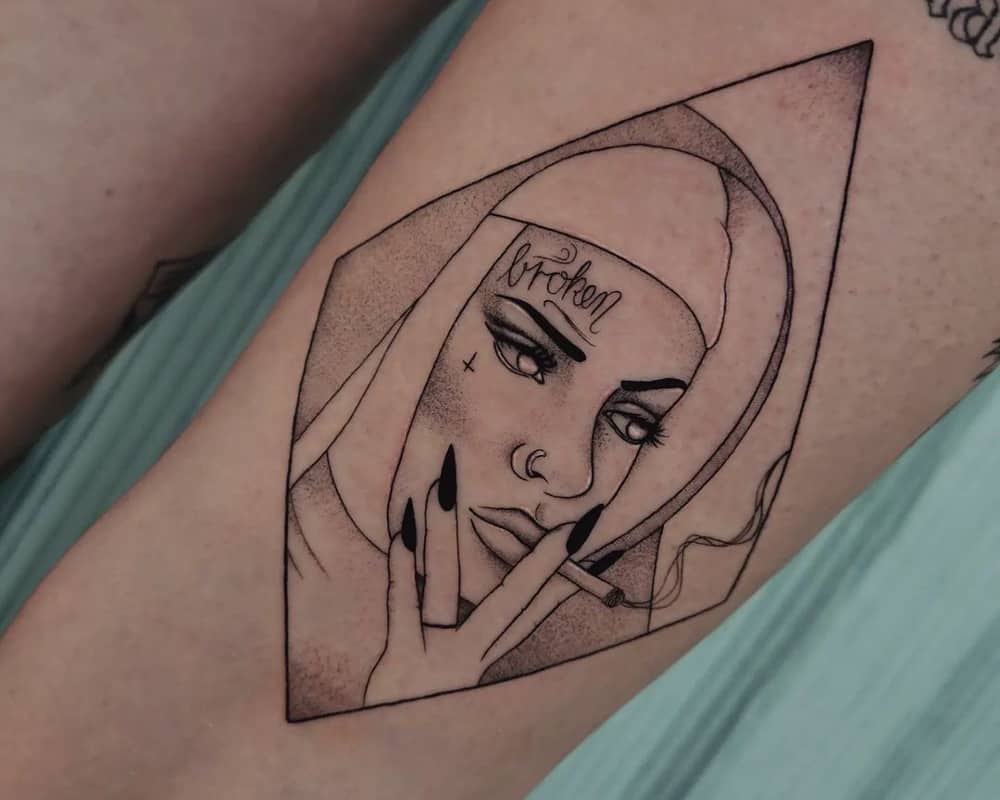 A tattoo in the shape of a smoking nun in a rhombus, with the write broken