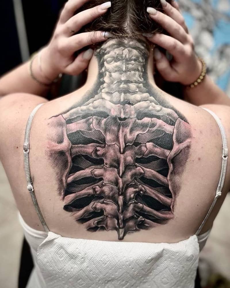 A tattoo in the shape of real bones on the back
