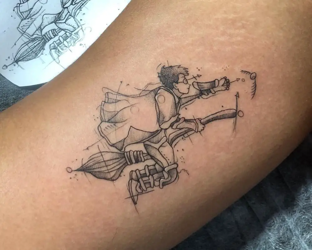 A tattoo of Harry Potter flying on a broomstick for a golden snitch