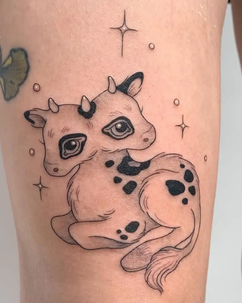 A tattoo of a cute lying two-headed calf on his arm