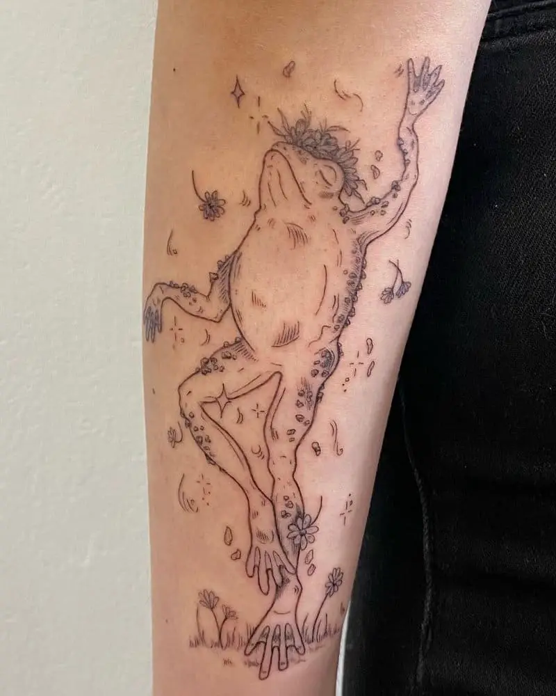 A tattoo of a dancing frog in flowers