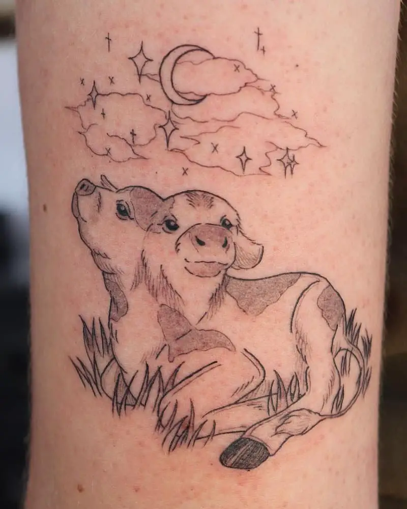 A tattoo of a lying two-headed calf looking up at the stars