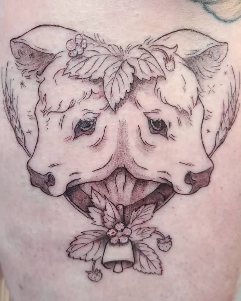A tattoo of a two-headed calf in the shape of a heart