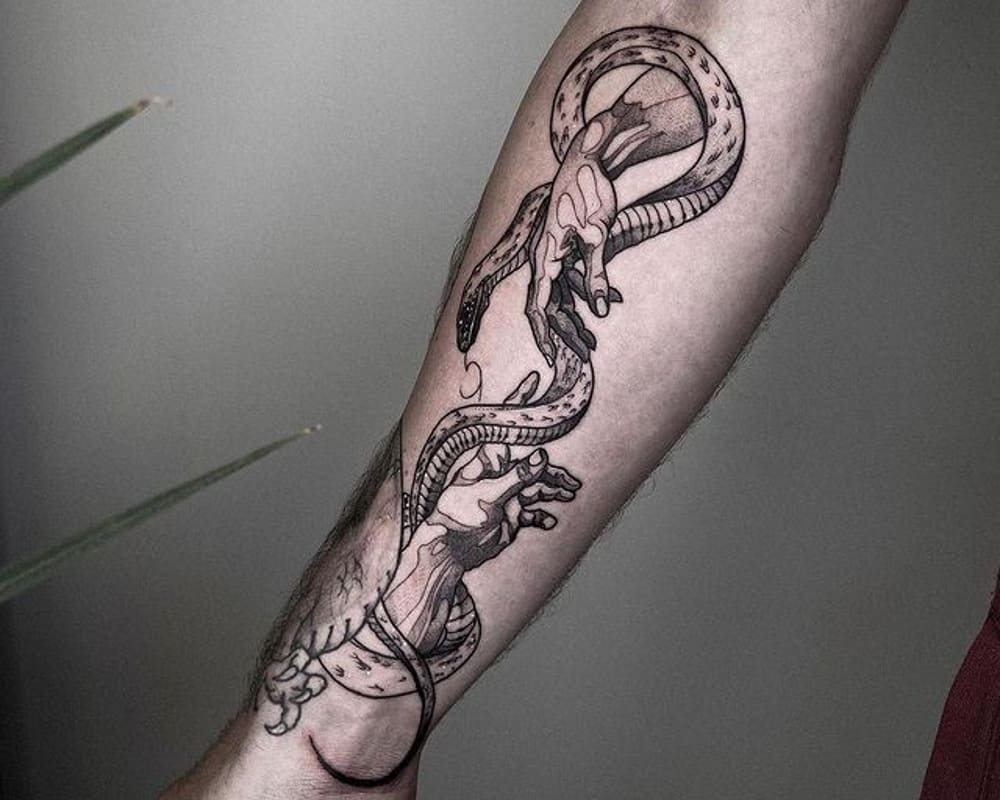 A tattoo of hands reaching out to each other and a snake intertwining them
