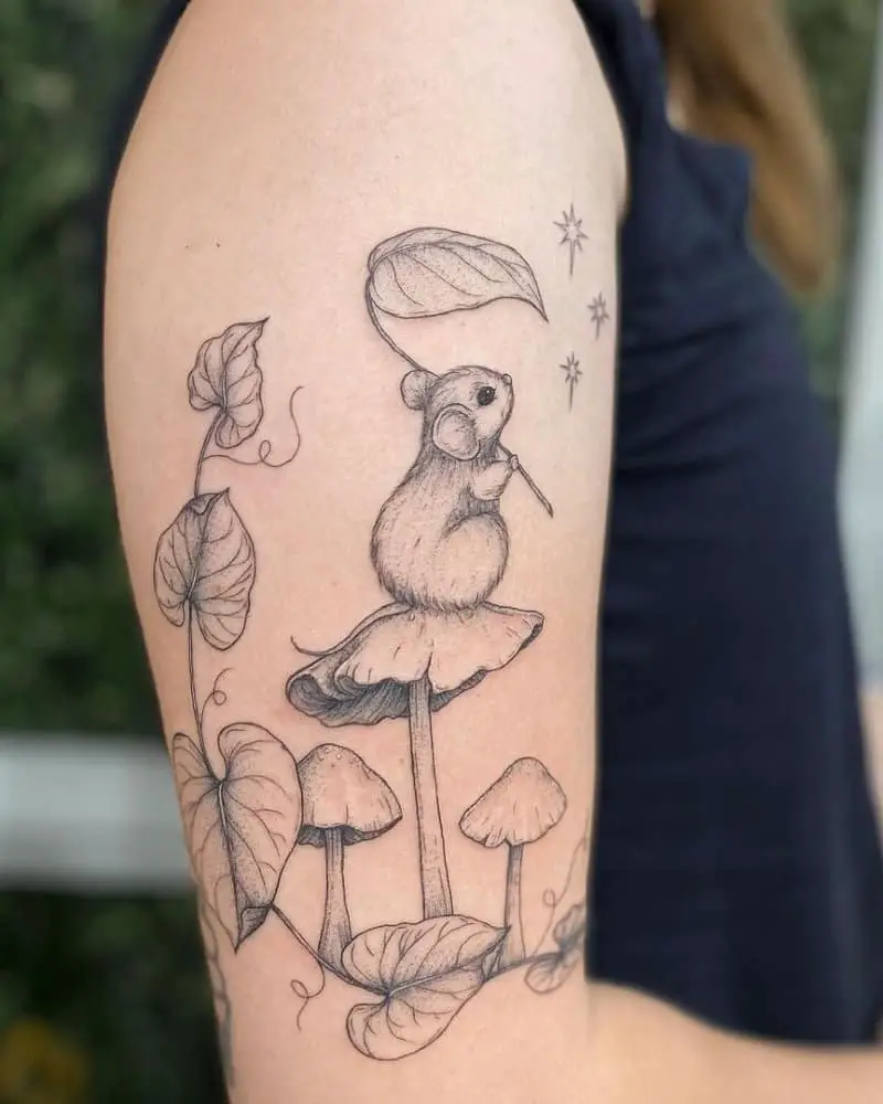 A very beautiful tattoo of a mouse with a leaf in its paws, sitting on a mushroom and looking at the stars