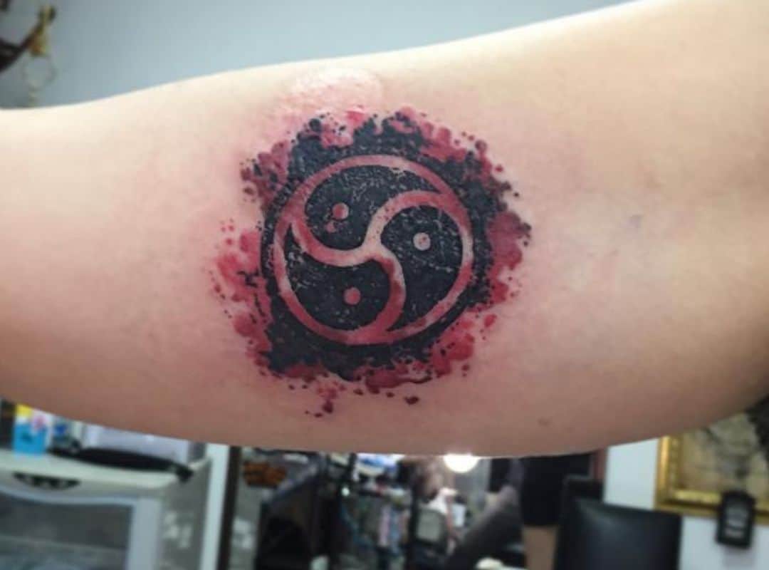 BDSM symbol in black and red colors tattoo