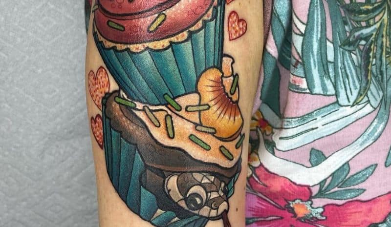 2 capcakes with brown and pink snake tattoo