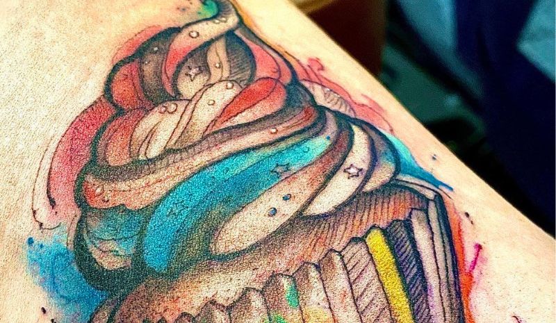 Colorful cupcake with black outline tattoo
