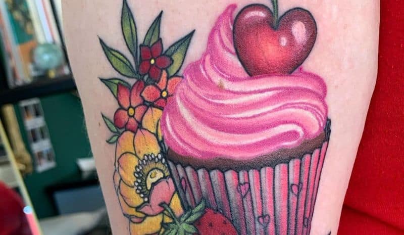 Pink cupcake with cherry and flowers tattoo