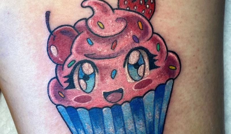 Blue and pink cupcake with eyes tattoo