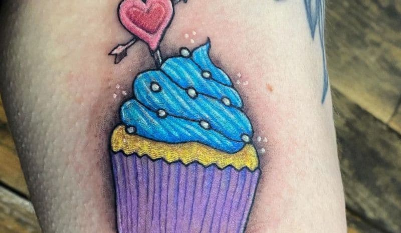 Blue, yellow and purple cupcake with heart tattoo