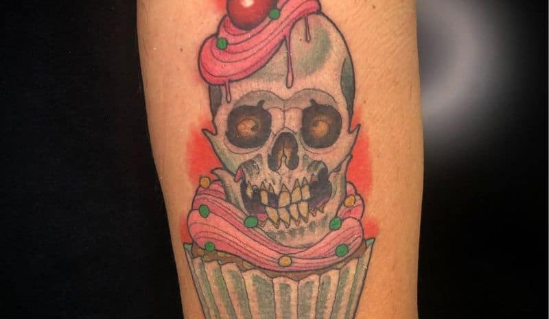 Skull in the centre of cupcake tattoo